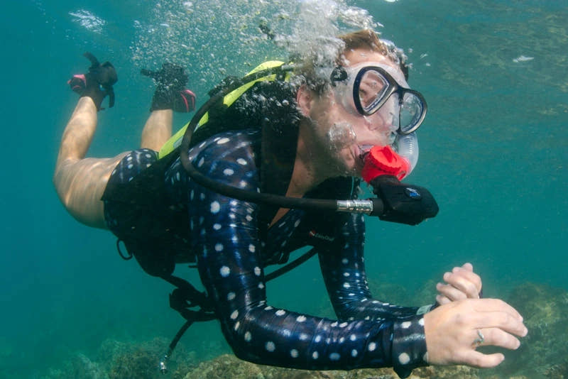 Side view of a diver underwater using an EasyDive Mini-SCUBA kit.