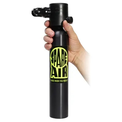 Hand holding the Spare Air 300 cylinder to show compact handheld size and design.
