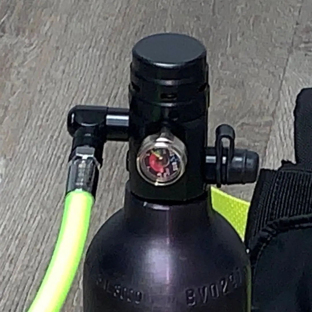 Close-up of Spare Air mini scuba regulator showing integrated pressure indicator gauge and high-visibility air hose connection.
